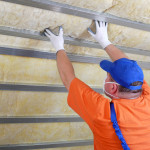 Man installing insulation.